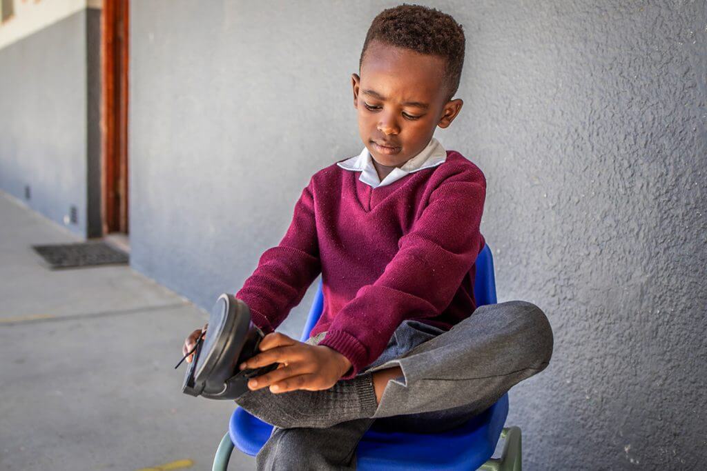 Joyful Smiles trying on school shoes